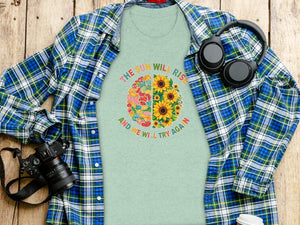 Light green t-shirt with a half brain design of patches and sunflowers, with text.