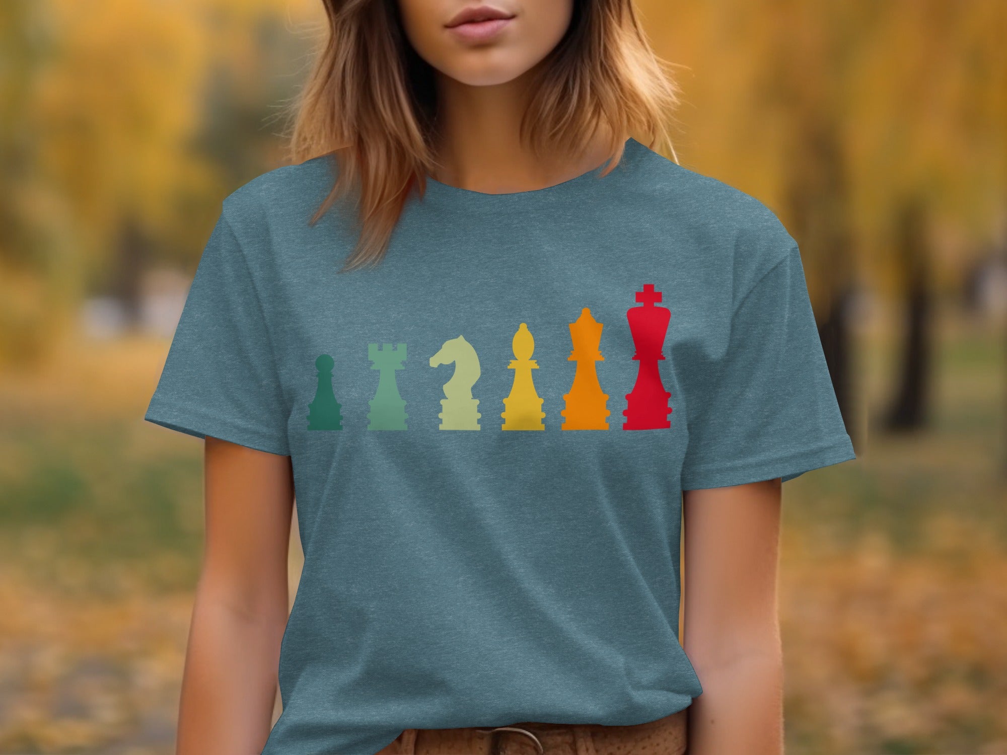T-shirt with row of colorful vintage chess pieces: rook, knight, bishop, queen, and king.