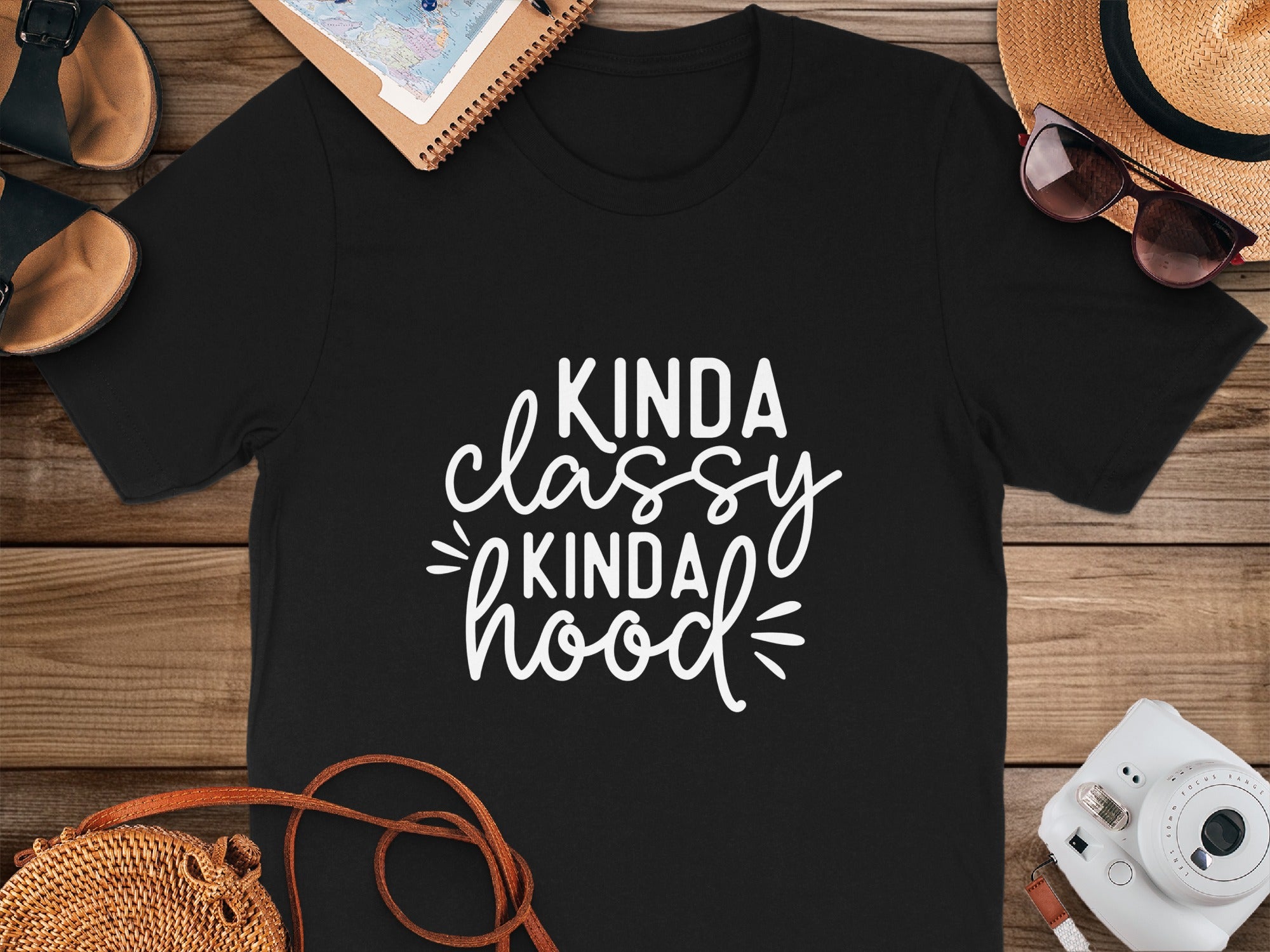 Black t-shirt with "Kinda Classy Kinda Hood" white text, surrounded by summer accessories.