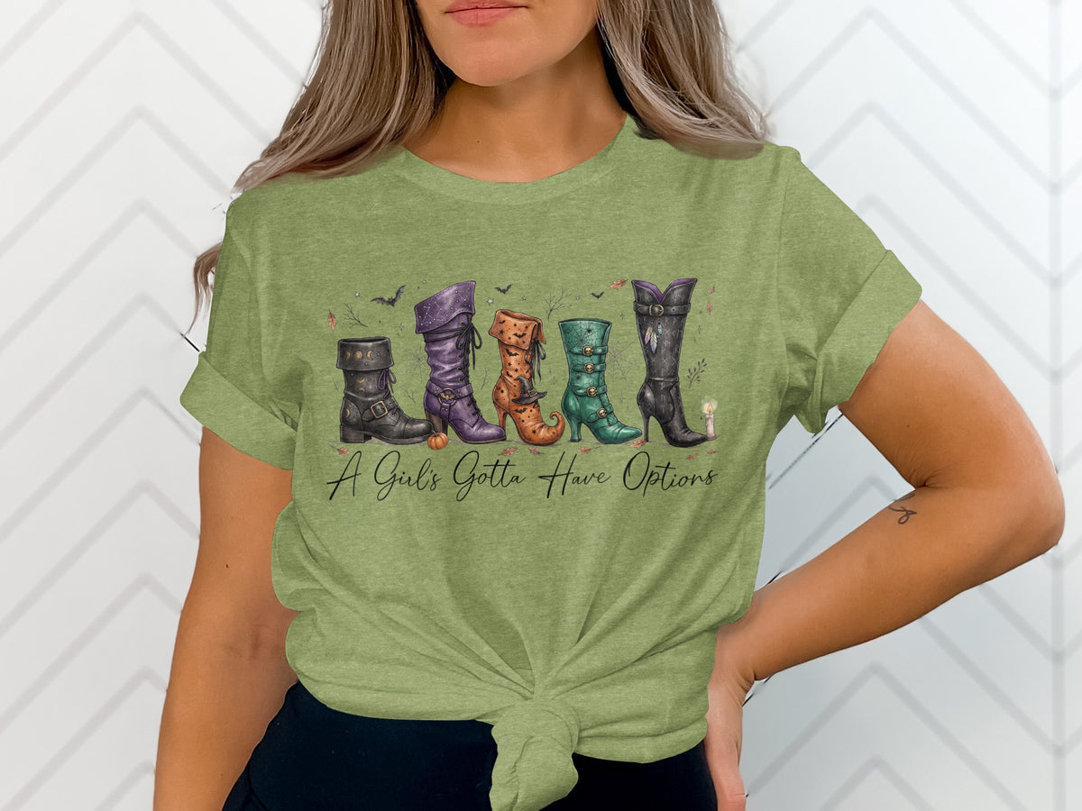 Green t-shirt with five Halloween-themed boots and text "A Girl's Gotta Have Options".