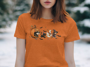 Orange t-shirt with Halloween characters including a pumpkin, ghost, cat, duck, and witch.