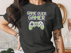 Dark t-shirt with pixelated "GAME OVER GAMER" text and a green video game controller.
