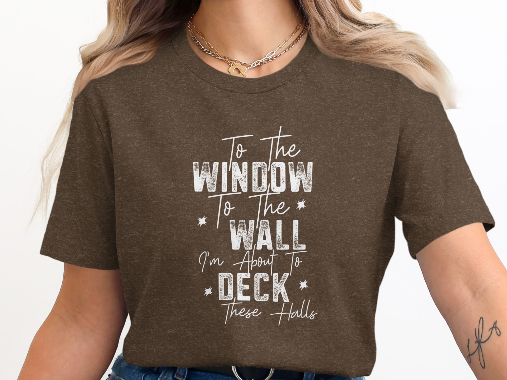 Brown t-shirt with white text: To The Window To The Wall I'm About To Deck These Halls.