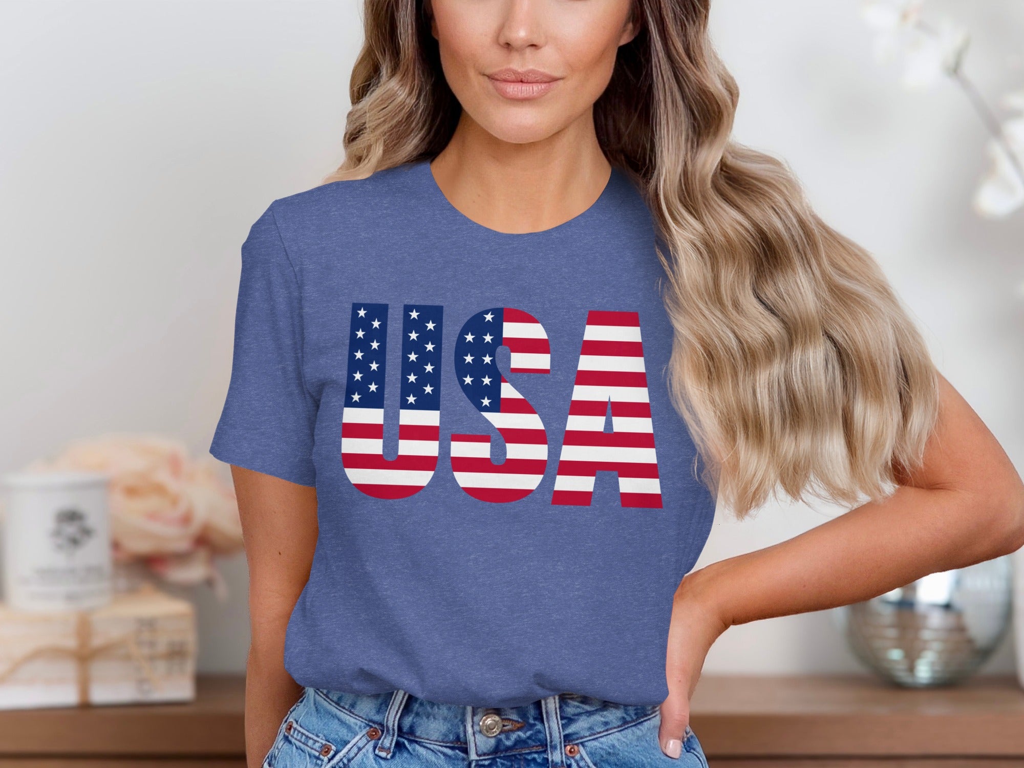 Woman wearing blue t-shirt with large "USA" text in American flag design.