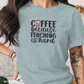 Light blue t-shirt with "Coffee because teaching is hard" graphic.