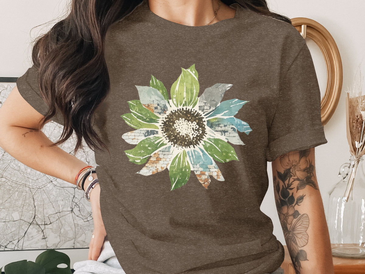 Brown t-shirt with watercolor sunflower print featuring brick and sky details.