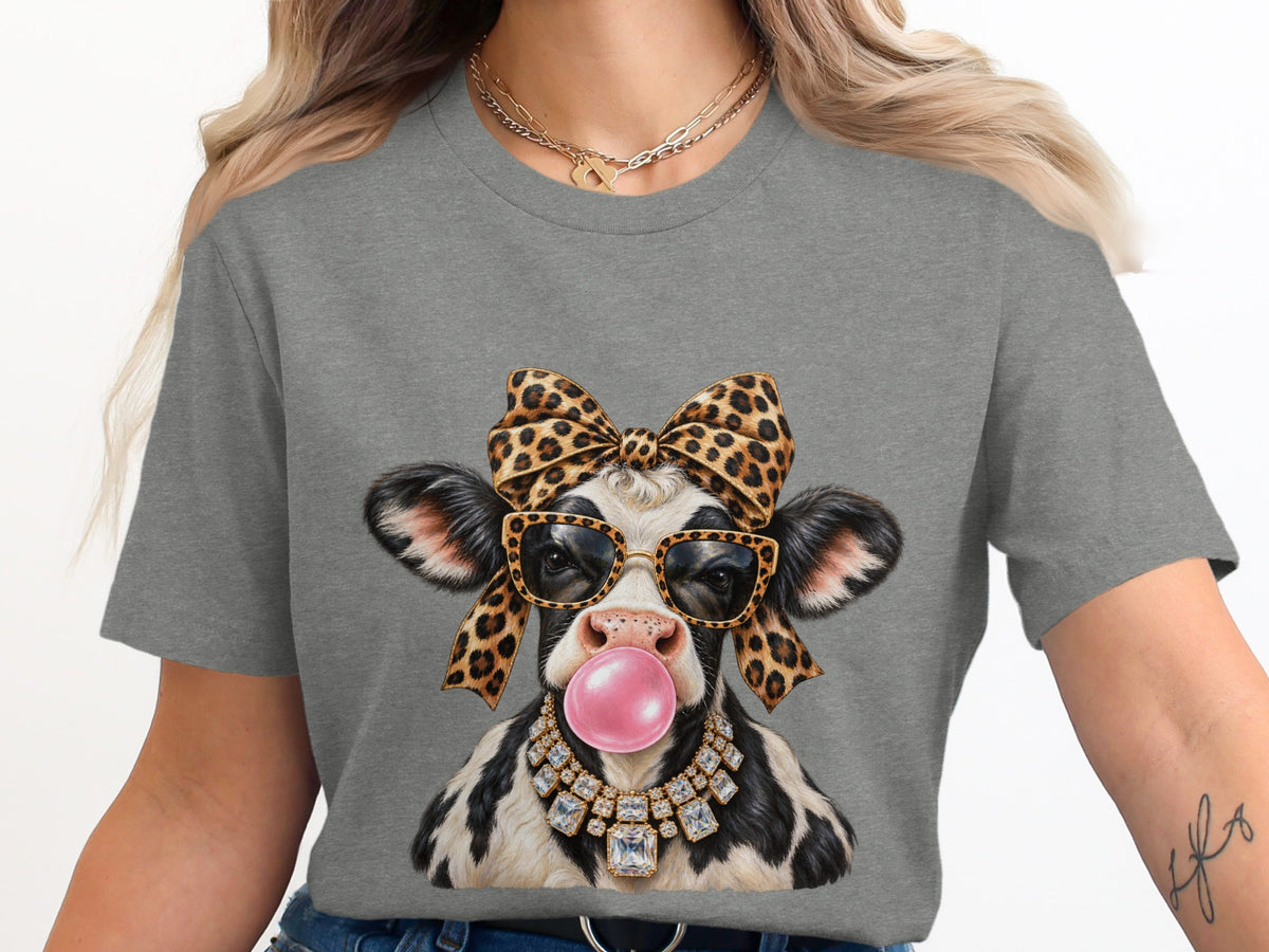 Cow graphic with leopard bow, sunglasses, bubblegum, and diamond necklace on gray t-shirt.