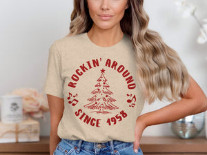 Tan t-shirt with red Christmas tree graphic and text "ROCKIN' AROUND SINCE 1958".