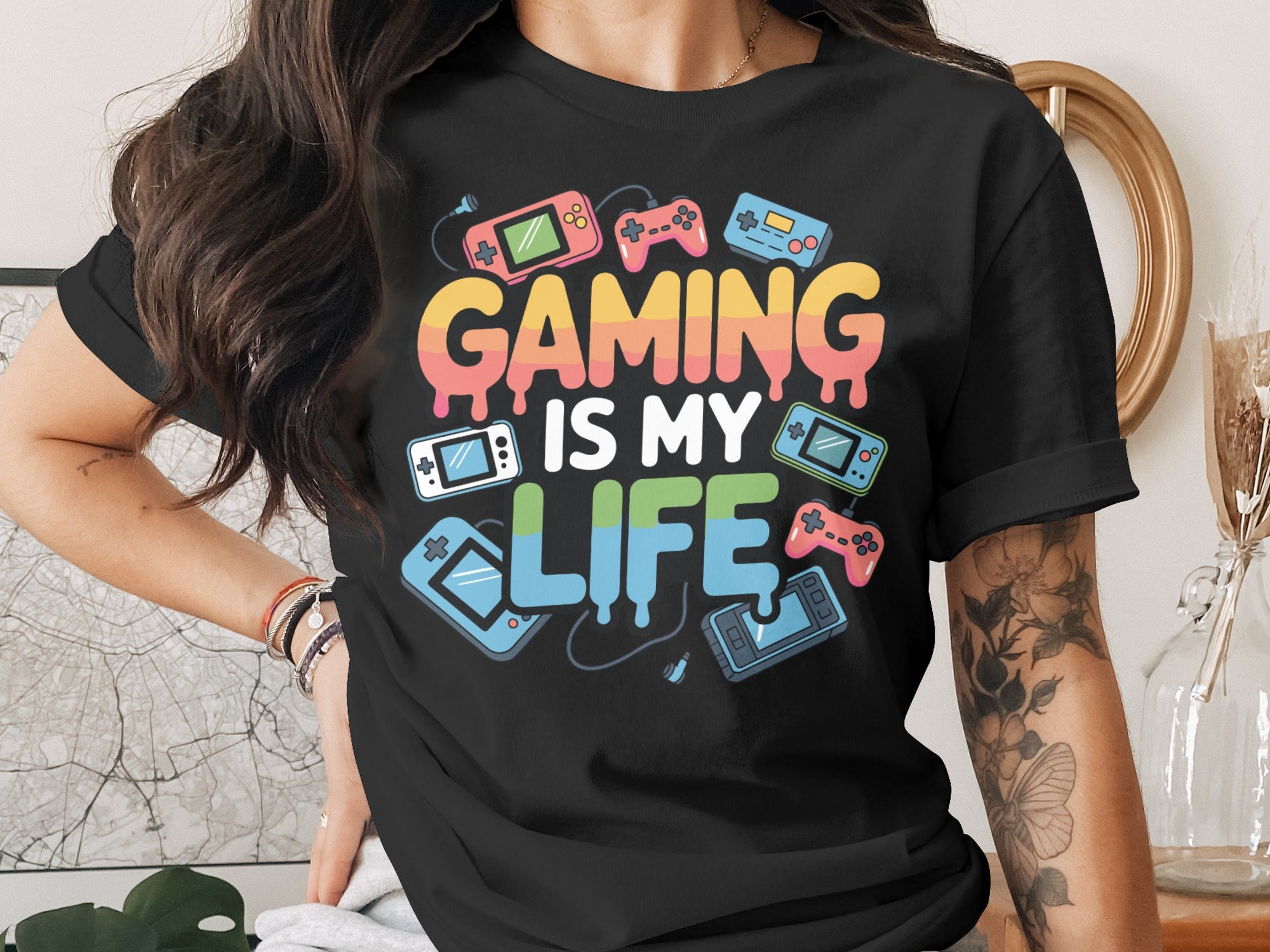 Black t-shirt with "GAMING IS MY LIFE" text and retro gaming graphics.