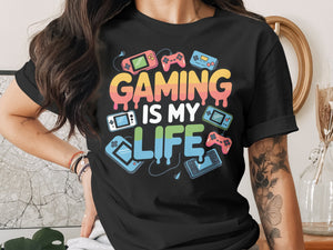 Black t-shirt with "GAMING IS MY LIFE" text and retro gaming graphics.