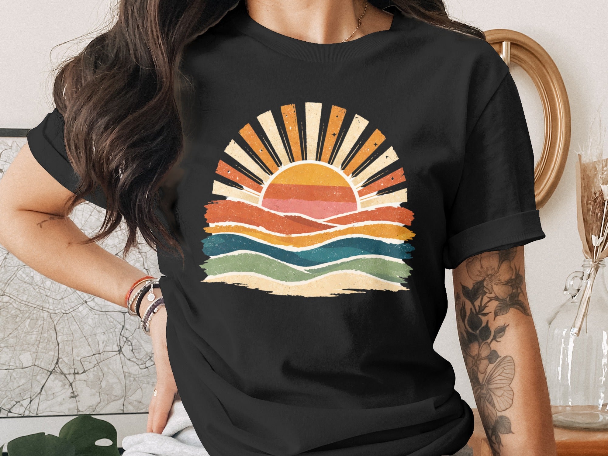 Black t-shirt featuring a retro sunset graphic with wavy lines.