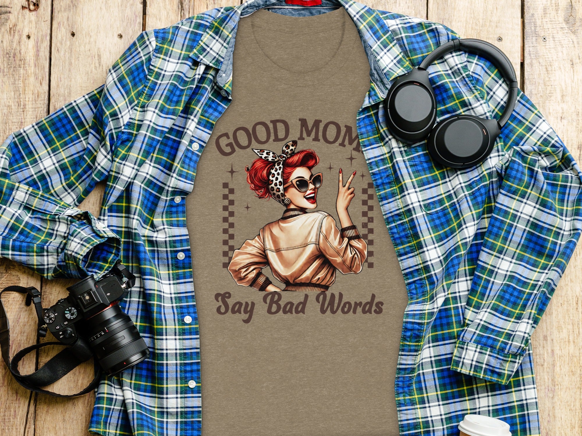 T-shirt with "Good Mom Say Bad Words" graphic, headphones, camera, and coffee cup.