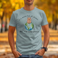 Light blue t-shirt with a cartoon capybara on Earth graphic and text.