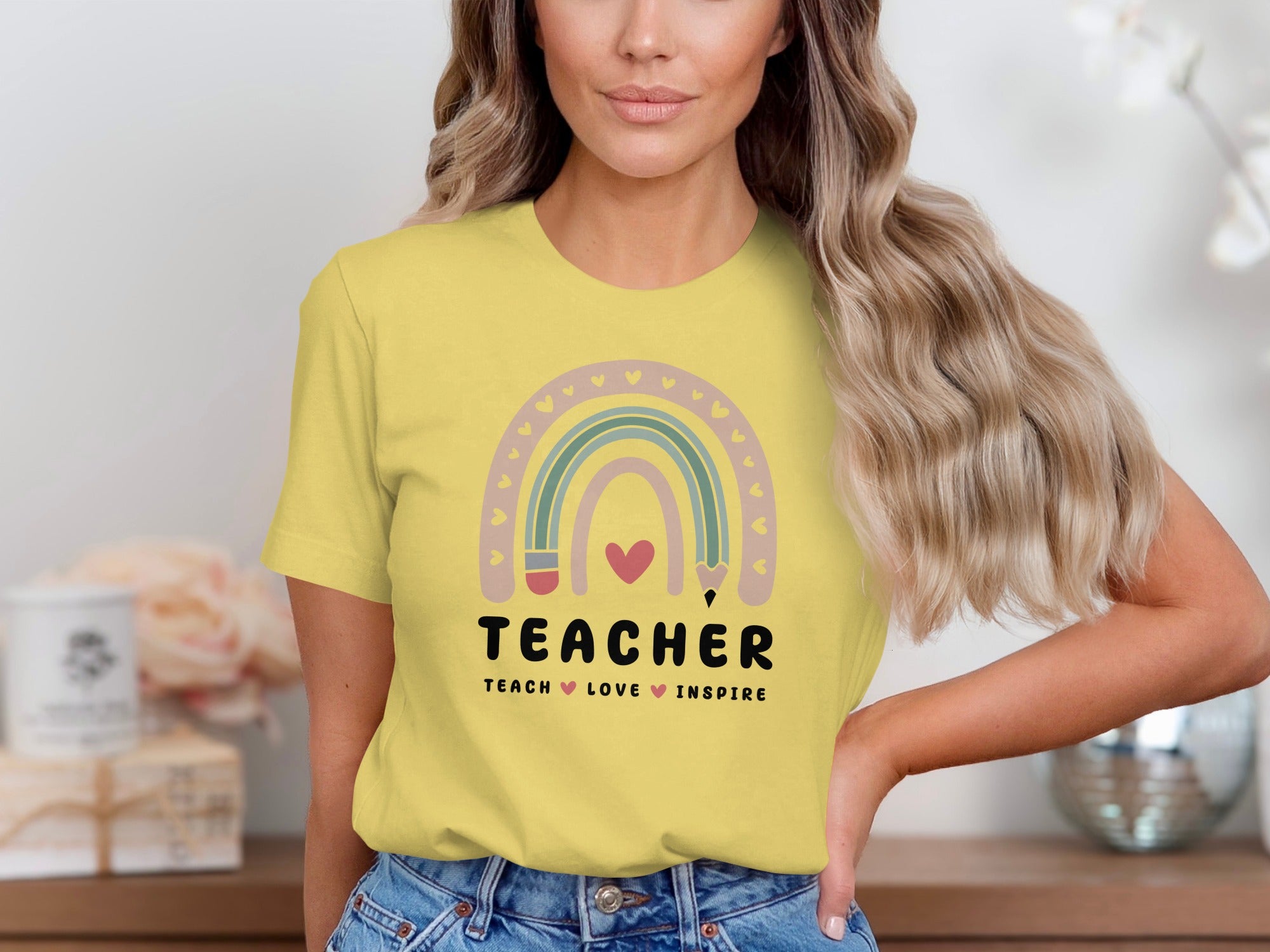 Yellow t-shirt with rainbow design and "TEACHER TEACH LOVE INSPIRE" text.