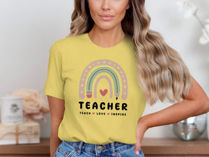 Yellow t-shirt with rainbow design and "TEACHER TEACH LOVE INSPIRE" text.