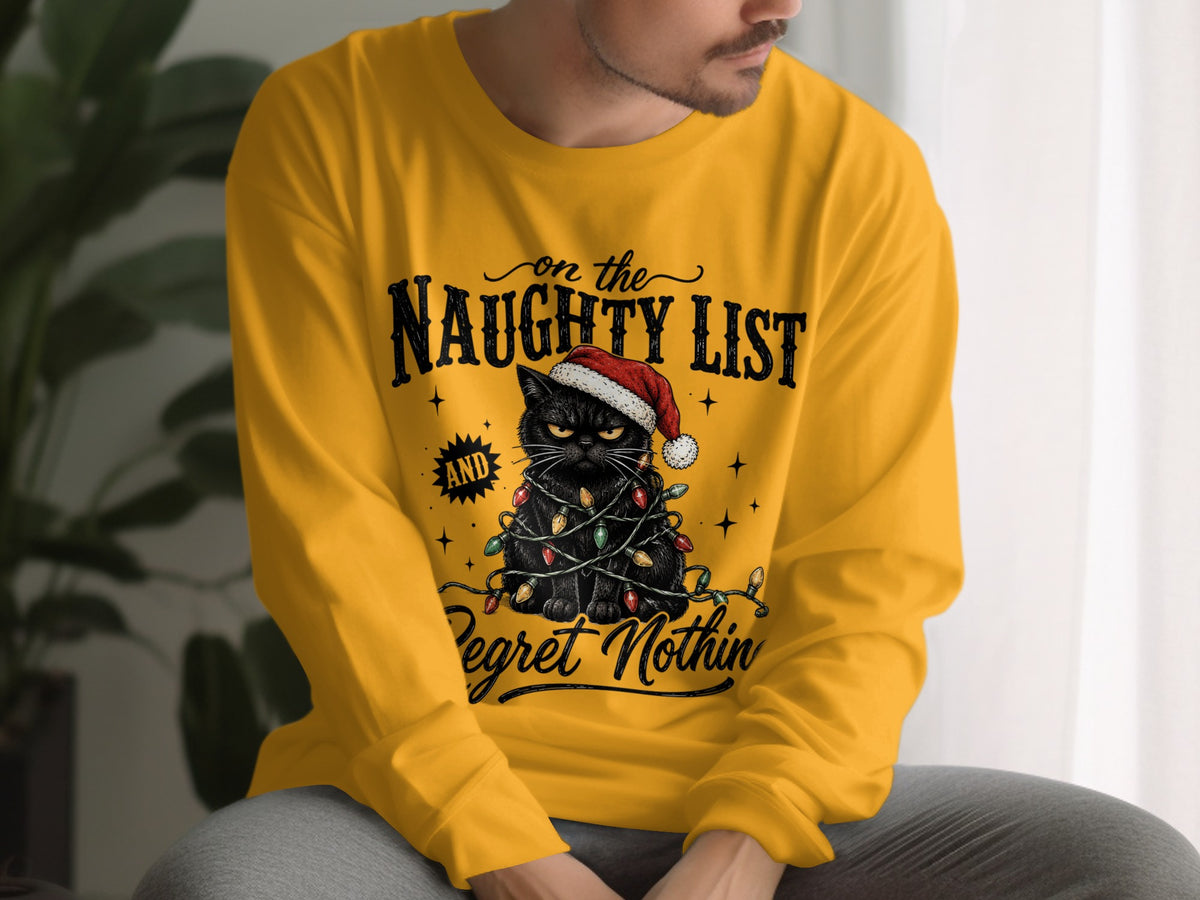 A man wearing a yellow long-sleeve t-shirt featuring a graphic of a black cat with Christmas lights and text.