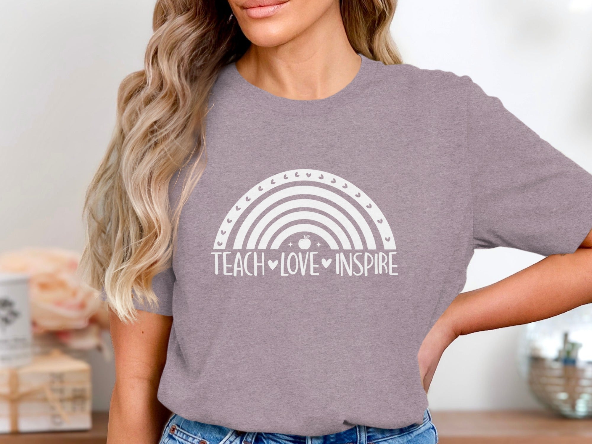 Grey t-shirt with a white rainbow graphic and text "TEACH LOVE INSPIRE".