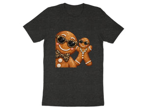 Two gingerbread figures wearing sunglasses and jewelry on a dark t-shirt.
