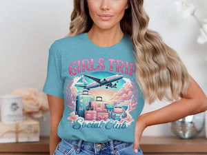 Teal t-shirt with "Girls Trip Social Club" graphic, airplane, luggage, and cocktail.