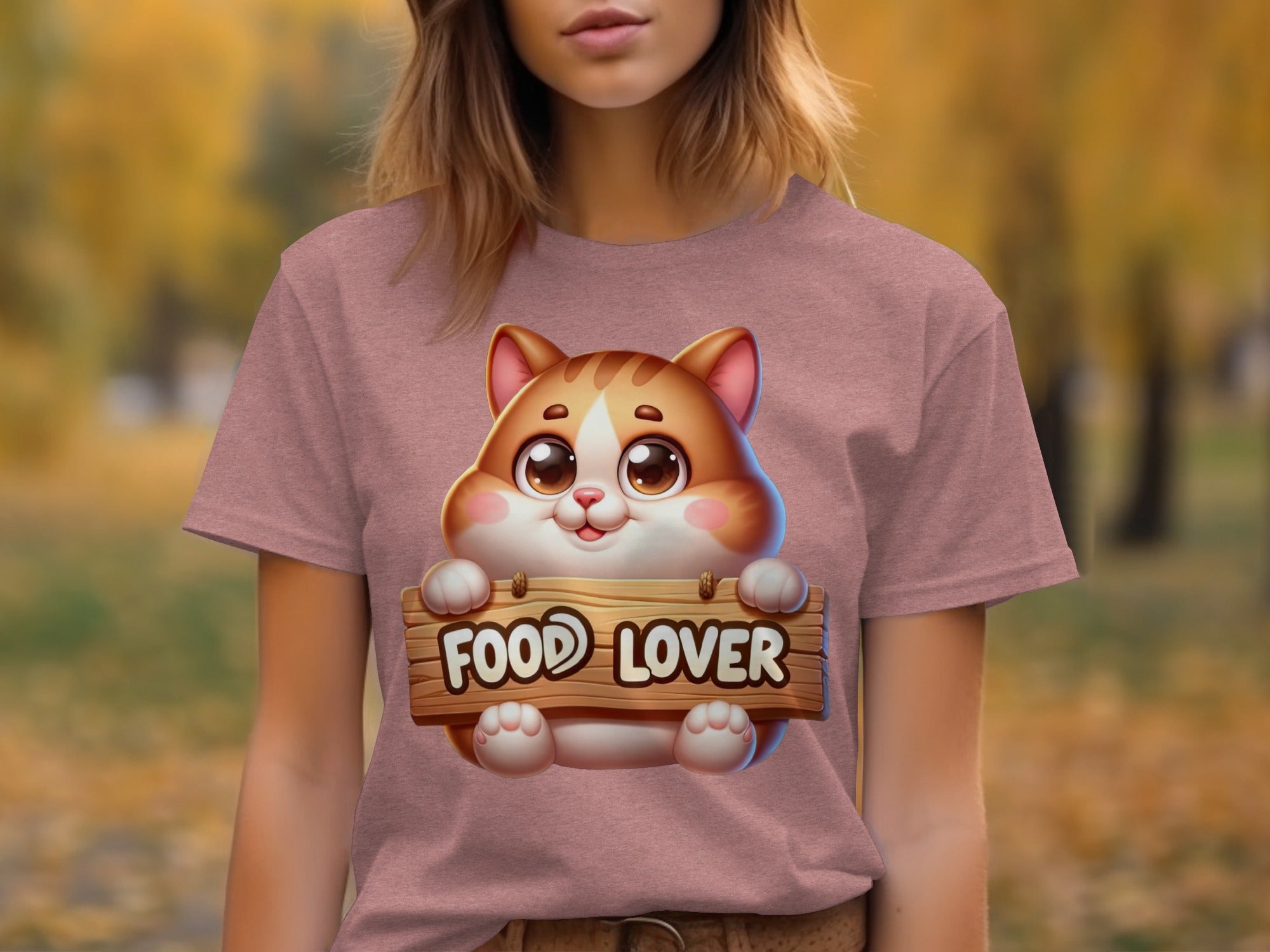Cute cartoon cat holding a "Food Lover" sign on a pink t-shirt