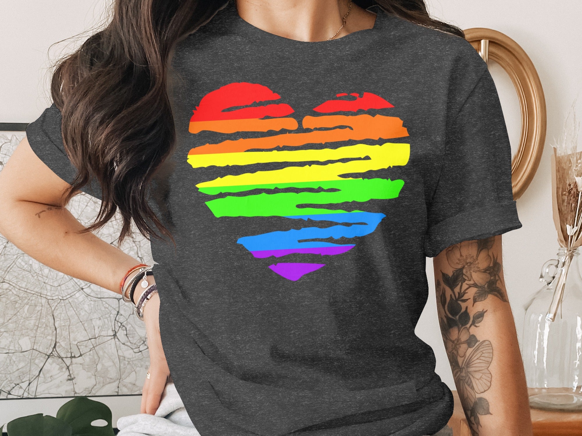 Dark t-shirt with a rainbow heart design and textured brushstrokes.