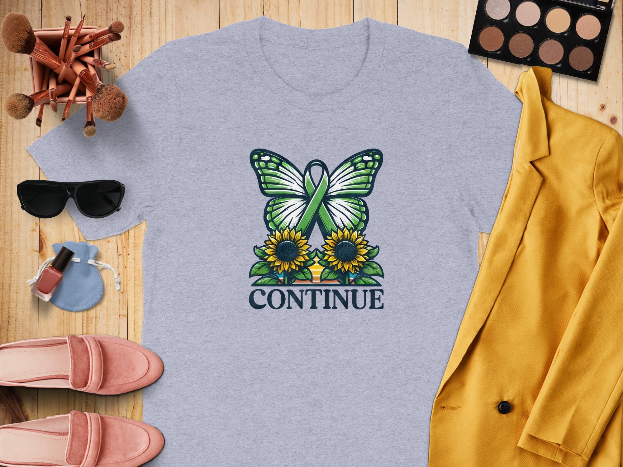 Grey t-shirt with butterfly, sunflowers, and "CONTINUE" text.