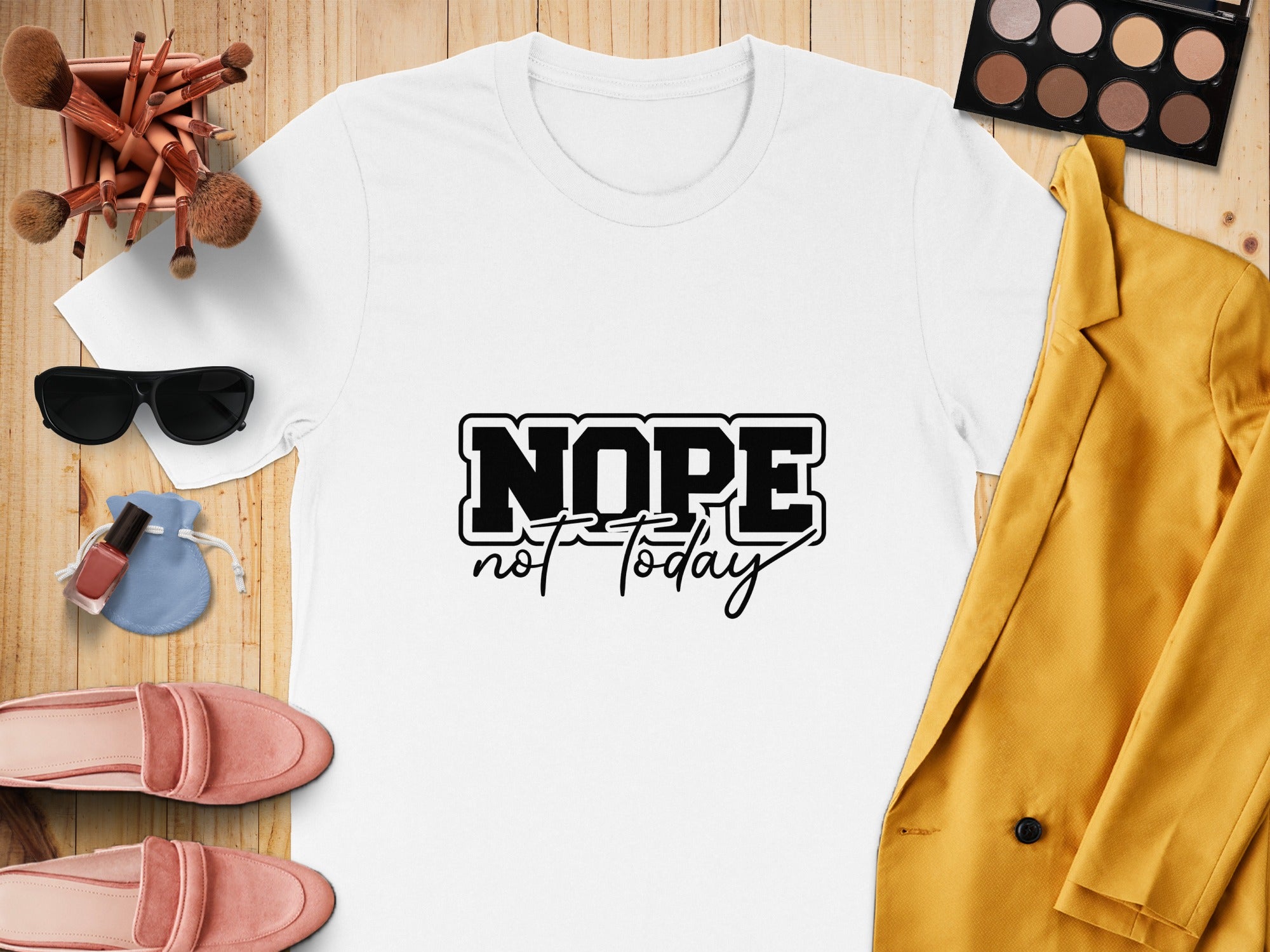 White t-shirt with black text "NOPE not today" surrounded by accessories.