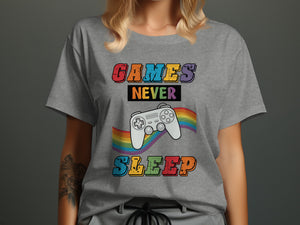 Gray t-shirt with "GAMES NEVER SLEEP" and a white video game controller on a rainbow.