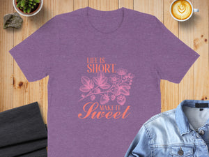 Purple t-shirt with "Life is Short Make it Sweet" strawberry graphic.