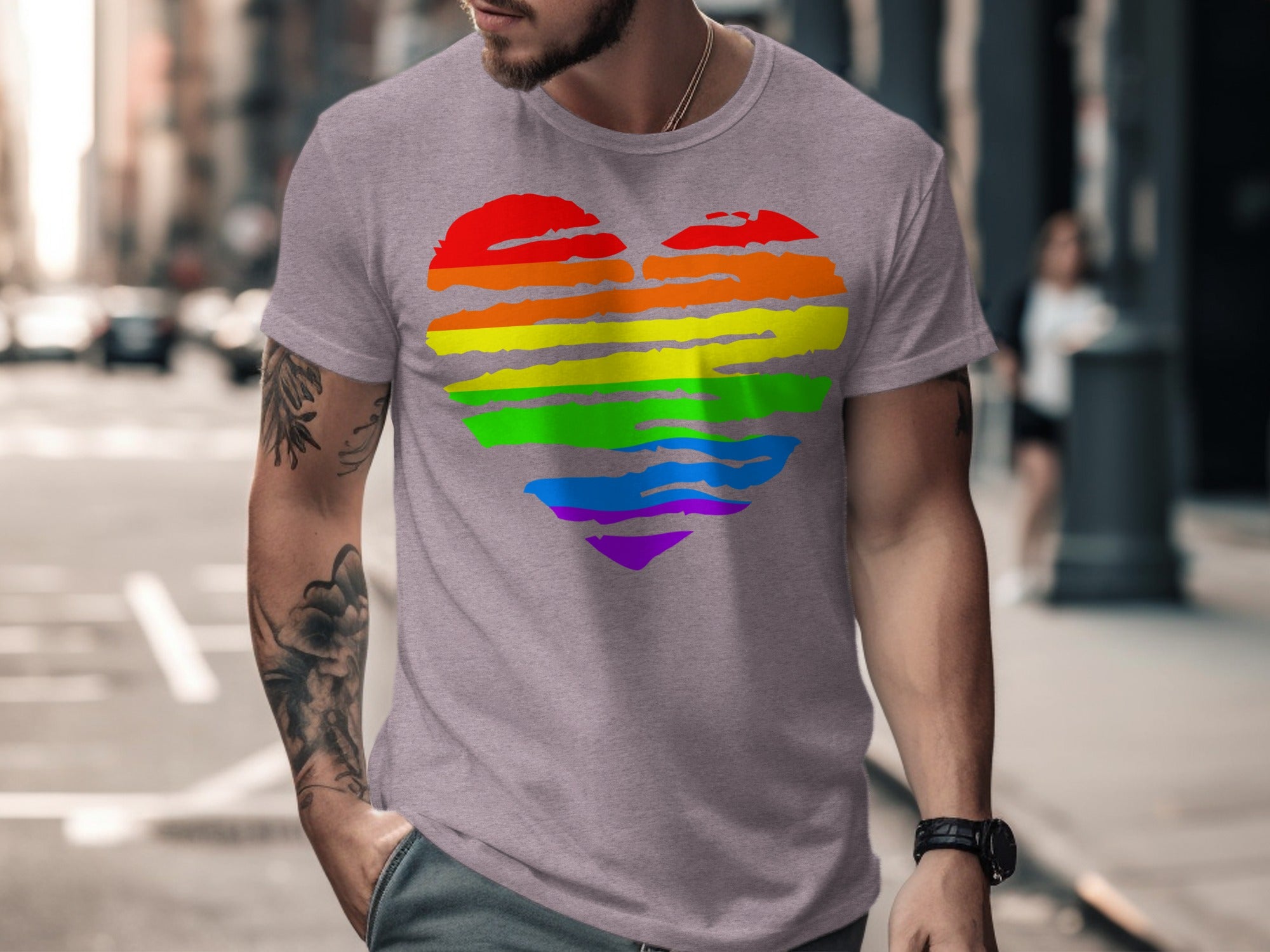 Man wearing grey t-shirt with rainbow heart graphic