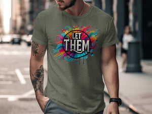 Green t-shirt with "LET THEM" text within a colorful, abstract design.