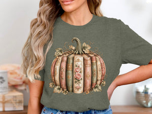 Green t-shirt featuring a pumpkin design made of vintage books with floral accents.