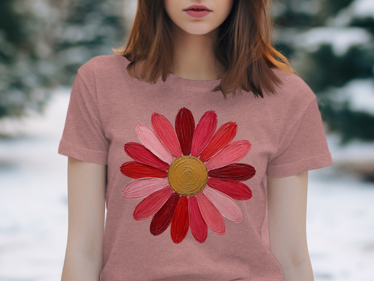 Pink t-shirt with a large, colorful flower graphic featuring red and pink petals.