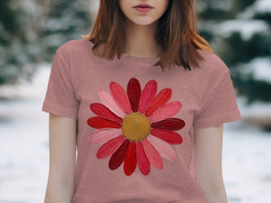 Pink t-shirt with a large, colorful flower graphic featuring red and pink petals.