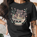 Black t-shirt with a kawaii black cat eating ramen from a decorative bowl.