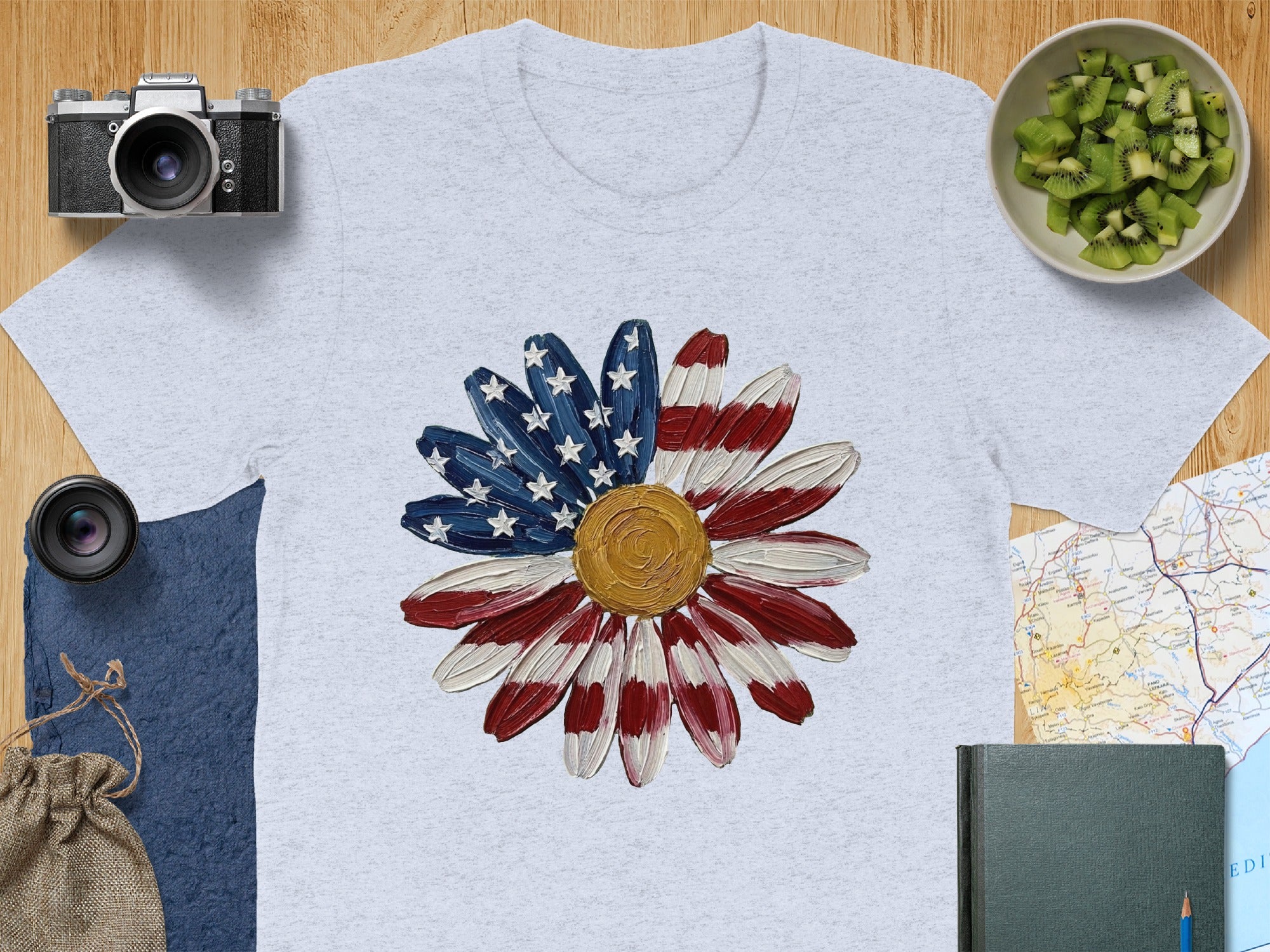 Light grey t-shirt featuring a daisy with American flag petals and gold center.