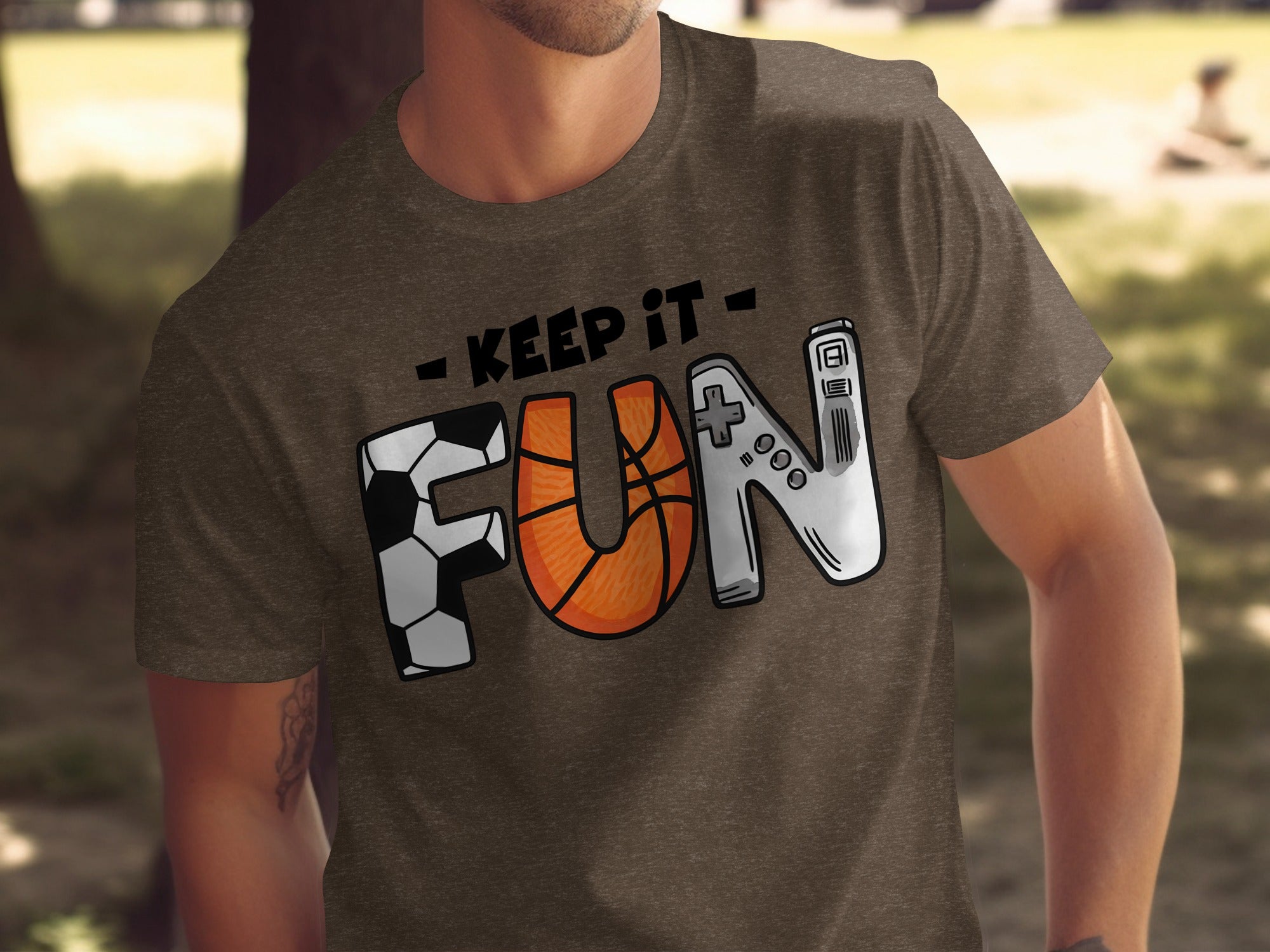 Brown t-shirt with "Keep It Fun" text and soccer, basketball, and video game controller graphics.