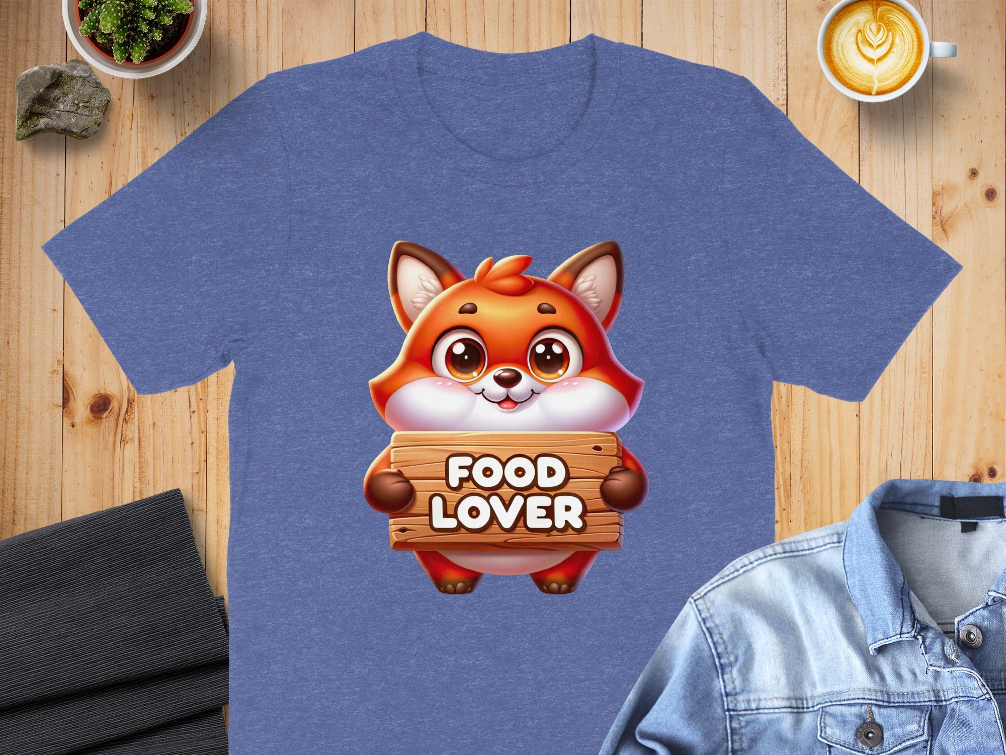 Cartoon fox holding a wooden sign that says "FOOD LOVER" on a blue t-shirt.