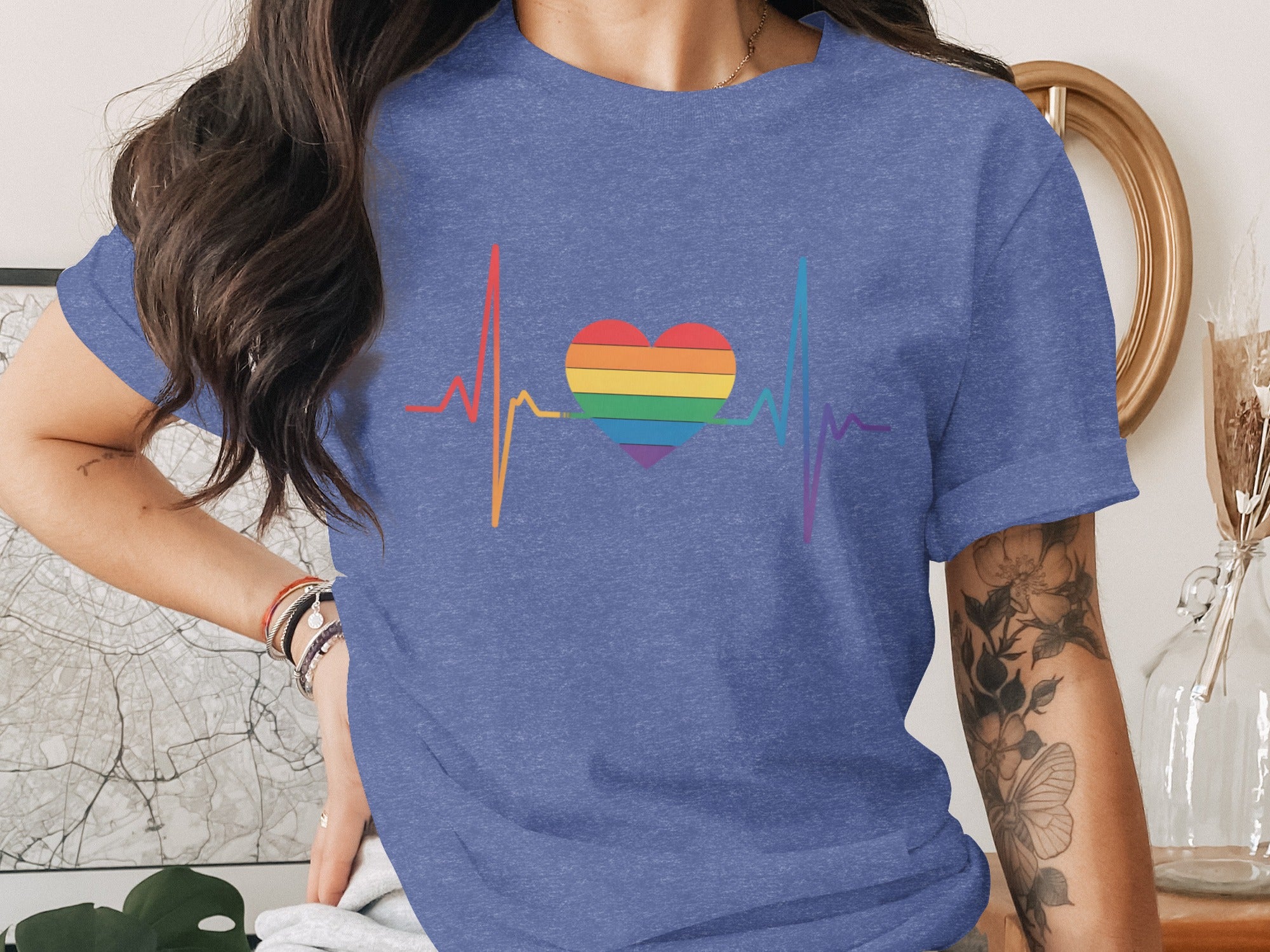 Blue t-shirt with rainbow heartbeat and heart graphic.