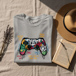 Grey t-shirt with colorful graffiti-style controller and gaming text.
