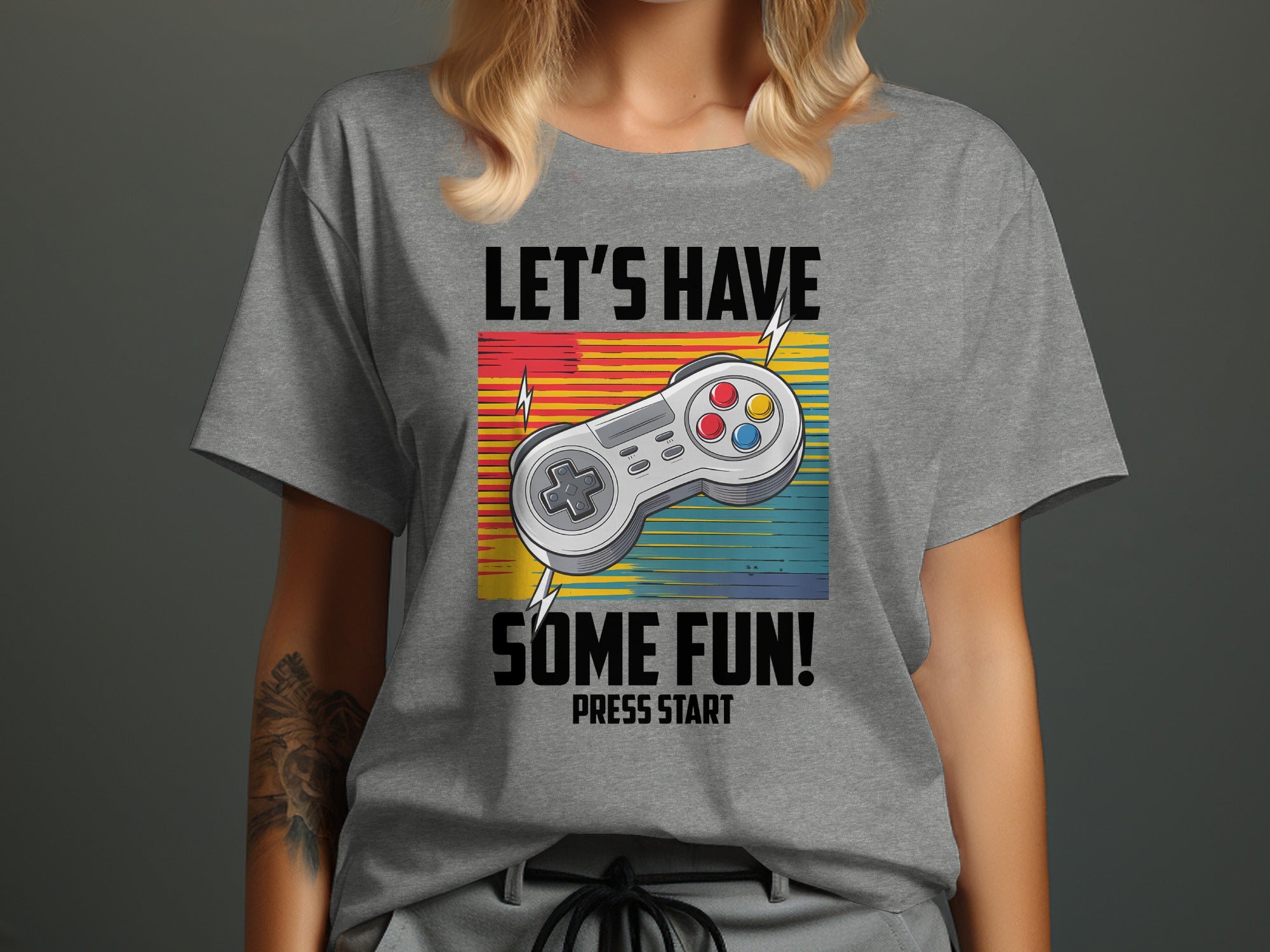 Gray t-shirt with "LET'S HAVE SOME FUN! PRESS START" and a video game controller.