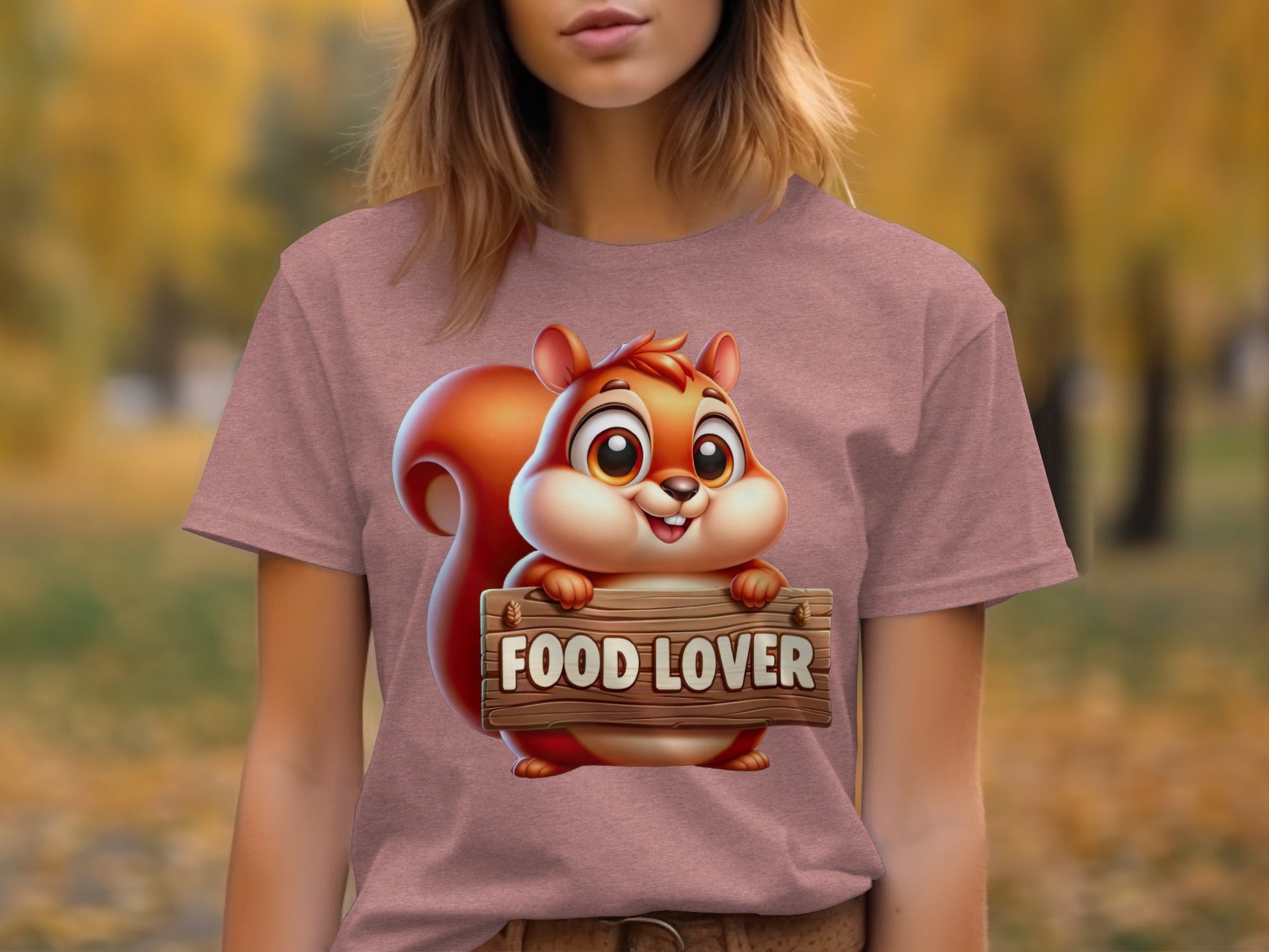 Cartoon squirrel holding a "FOOD LOVER" sign on a pink t-shirt.