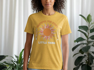 Yellow t-shirt with "GRATEFUL FOR EVERY LITTLE THING" text and graphic.