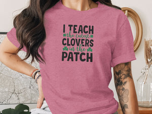 Pink t-shirt with black and green text "I TEACH the cutest CLOVERS in the PATCH".