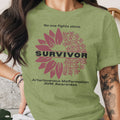 Olive green shirt with sunflower design supporting Arteriovenous Malformation awareness.