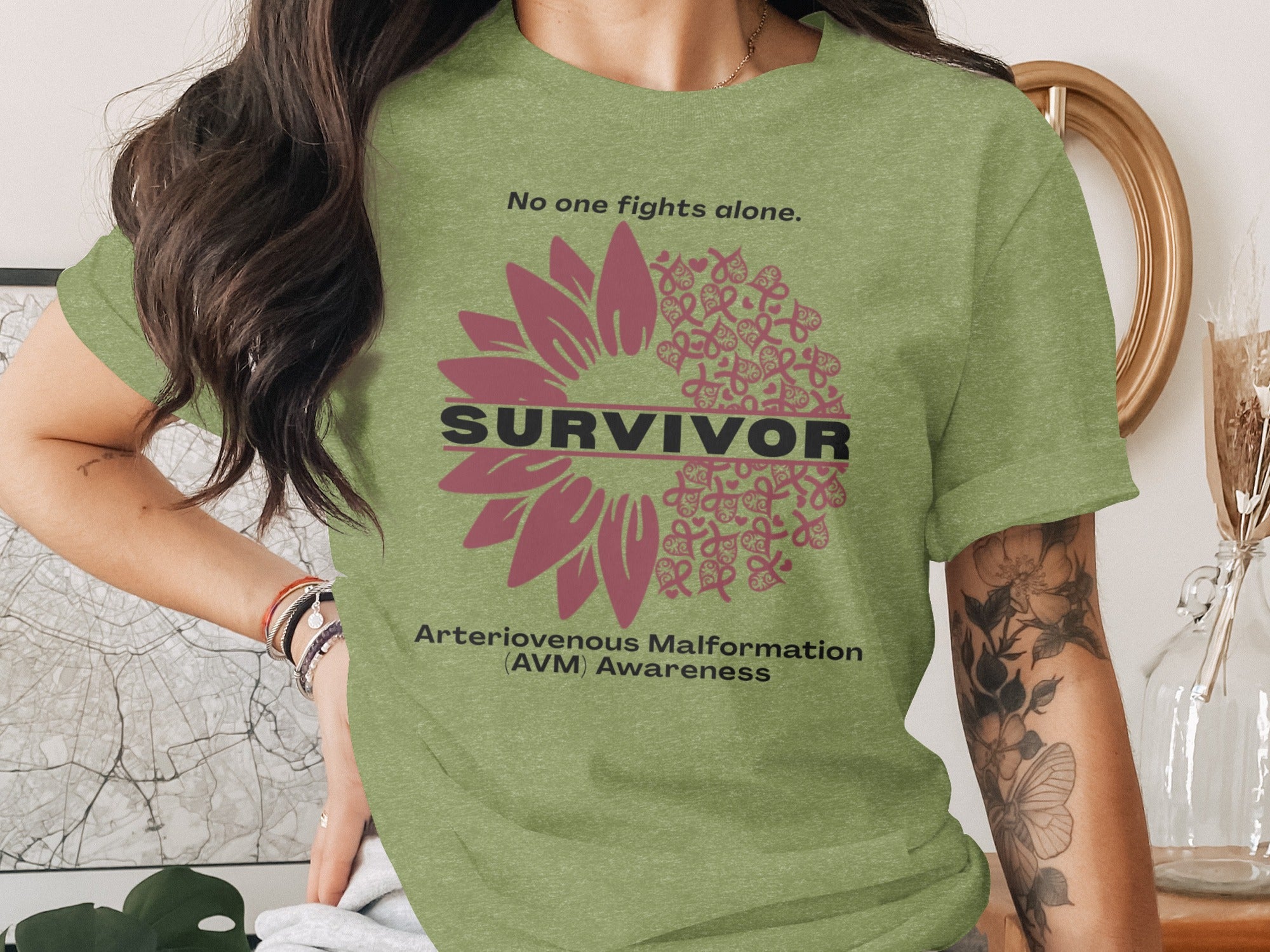 Olive green shirt with sunflower design supporting Arteriovenous Malformation awareness.