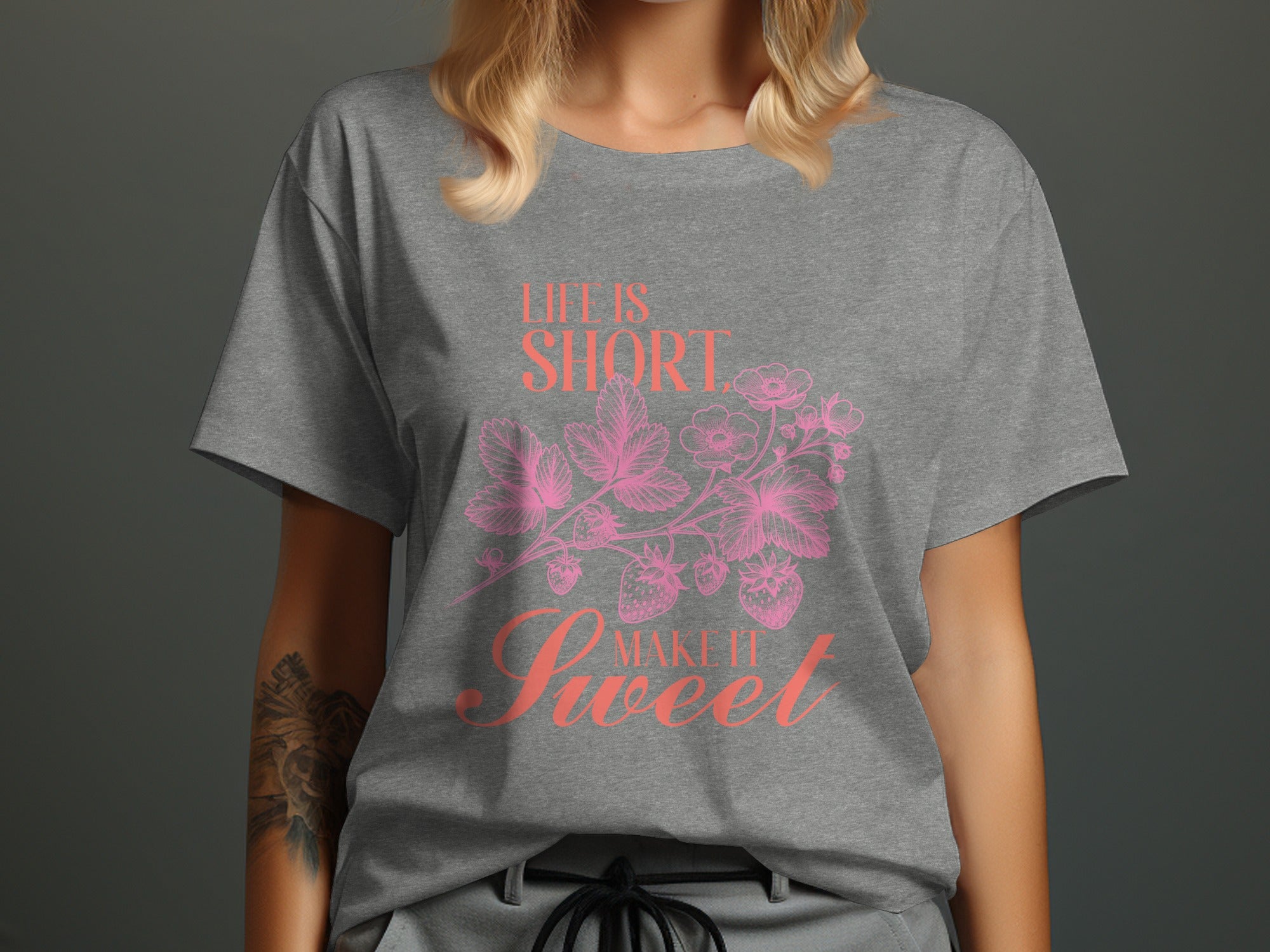 Grey t-shirt with pink 'Life is Short, Make it Sweet' strawberry graphic.