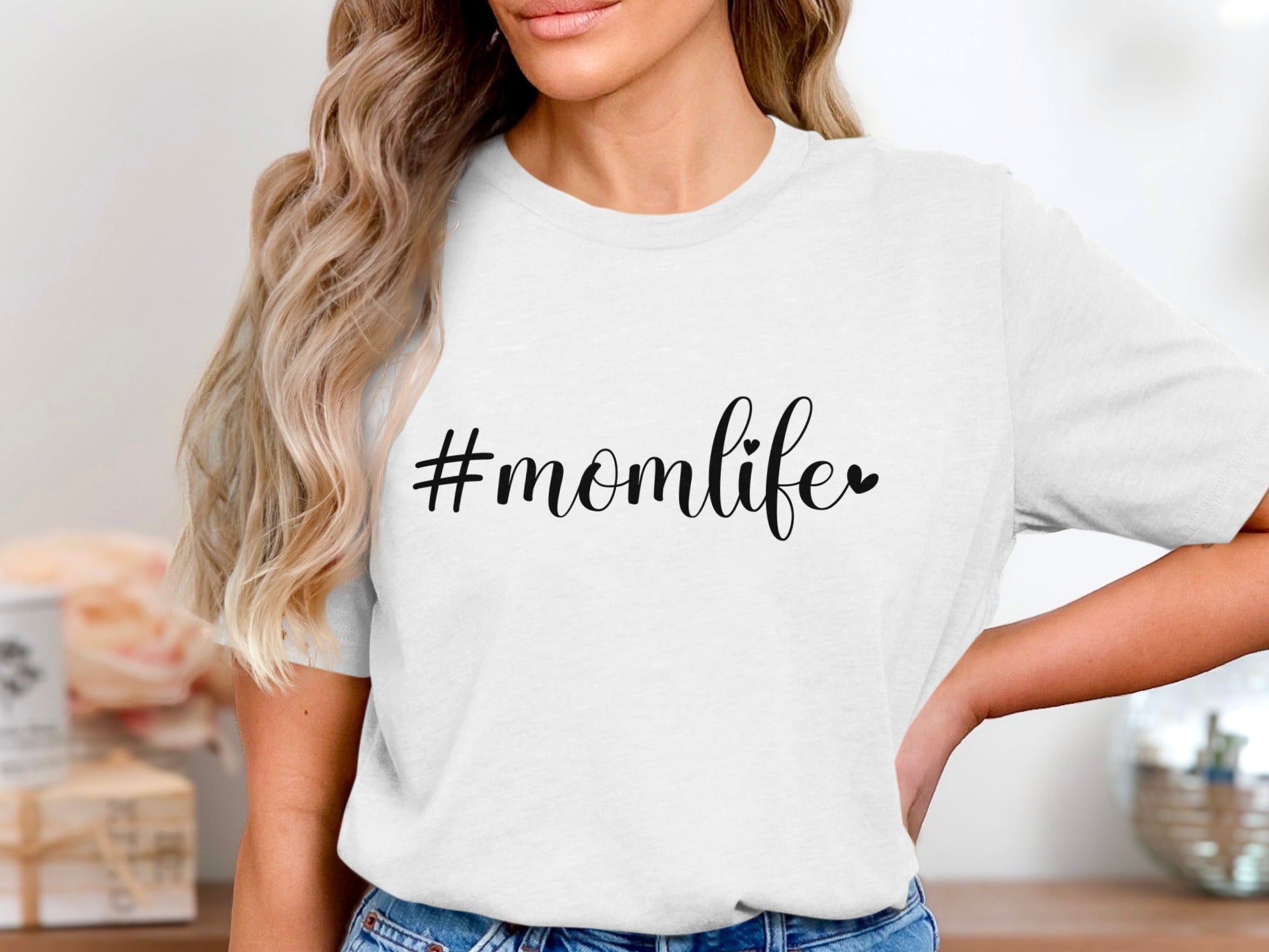 White t-shirt with "#momlife" graphic and heart accent.