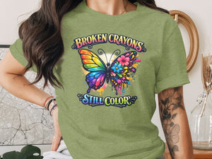 Green t-shirt with a butterfly design and text "BROKEN CRAYONS STILL COLOR."