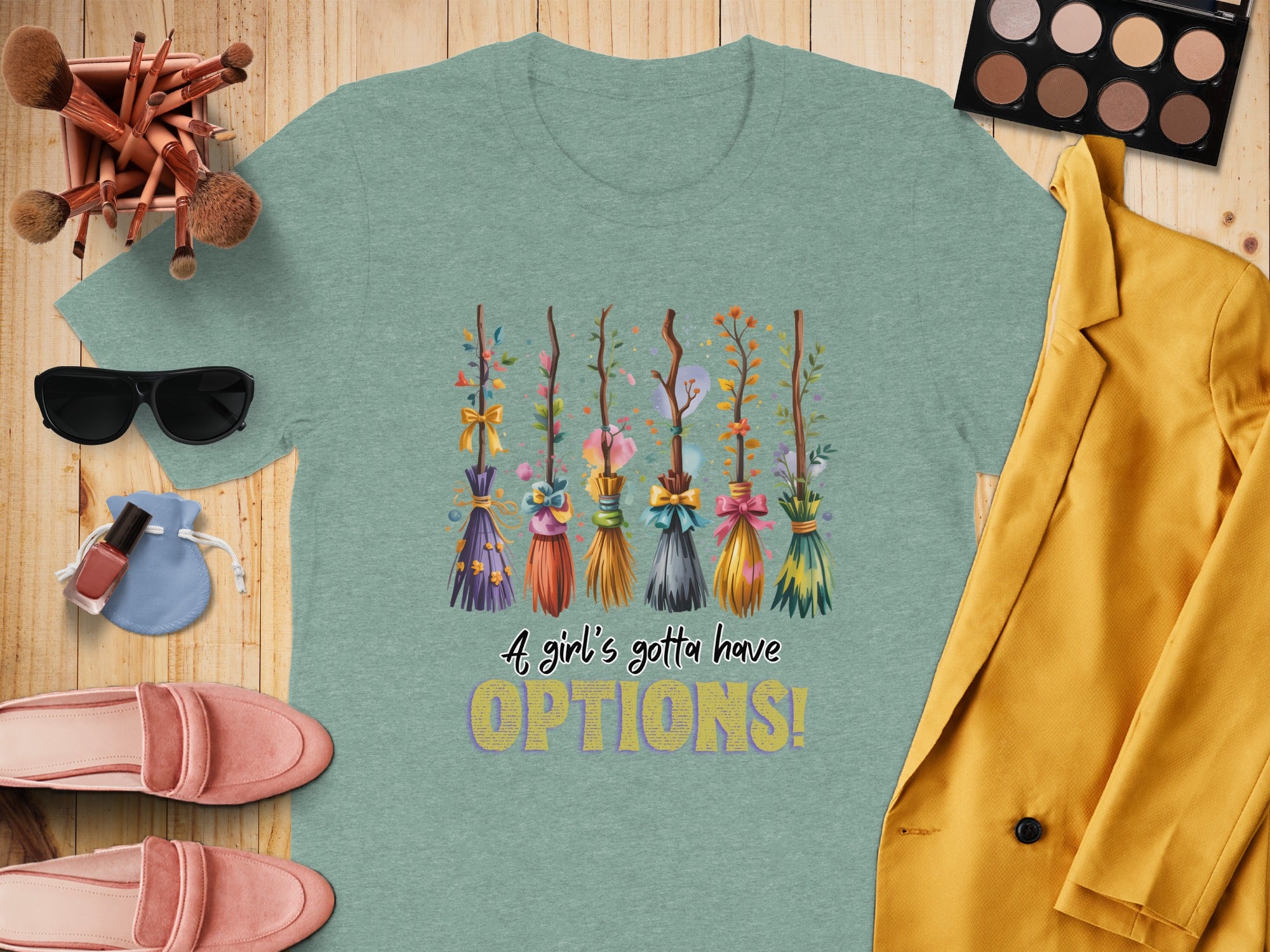 Green t-shirt with brooms and text "A girl's gotta have OPTIONS!"